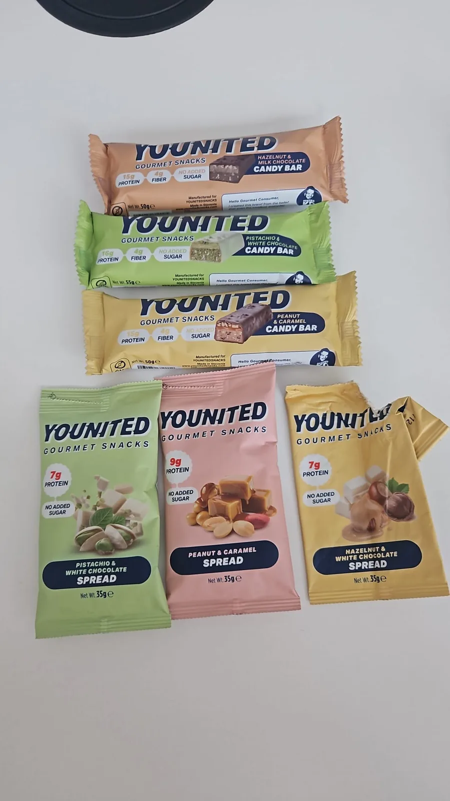 Physical YOUNITED candy bar and spread samples arranged on a table